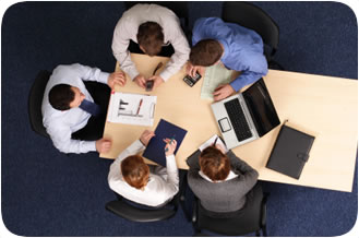 Staff sitting at table going over client's needs